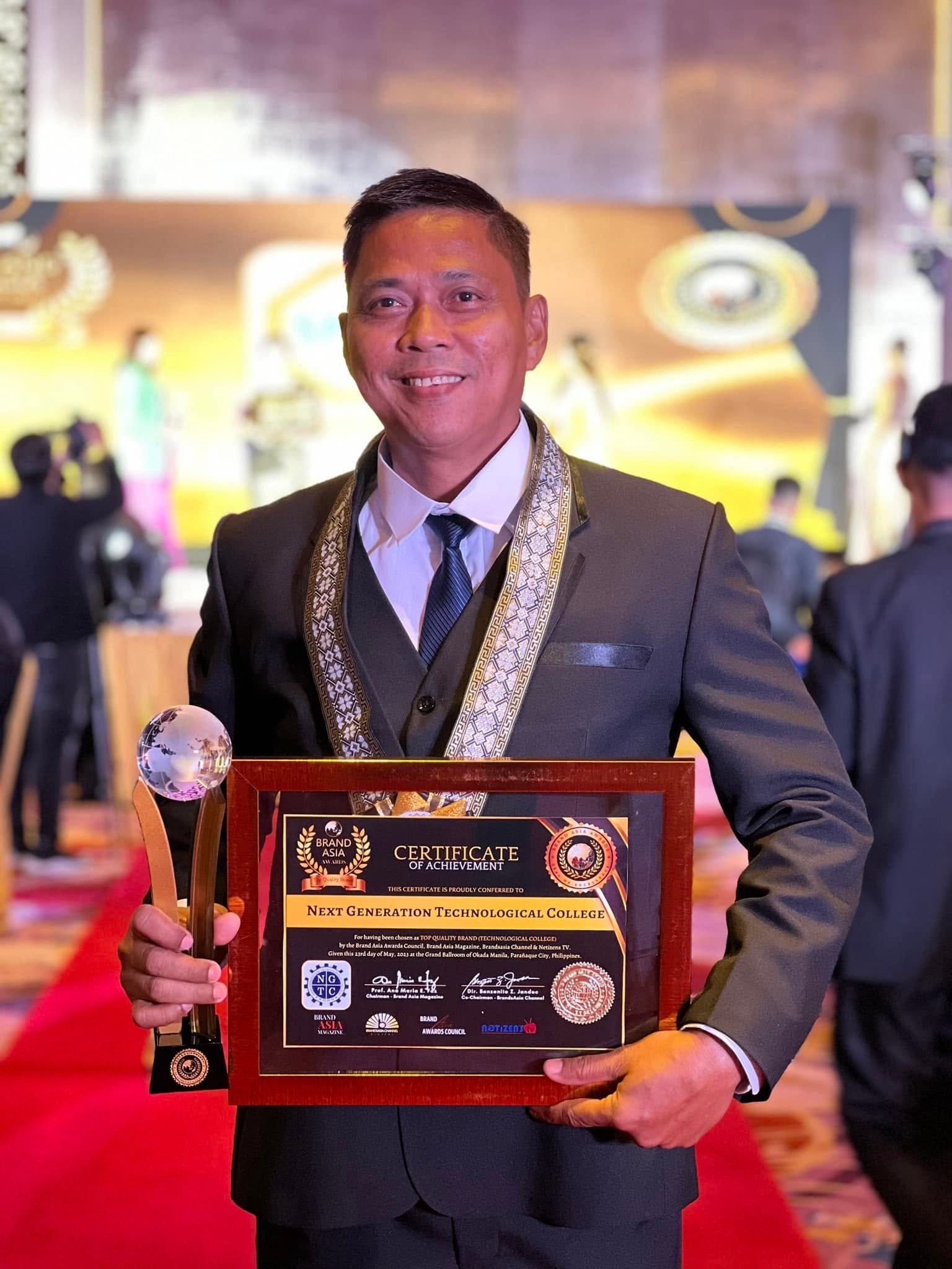 Albert Pagdanganan holding the Brand Asia Award and certificate